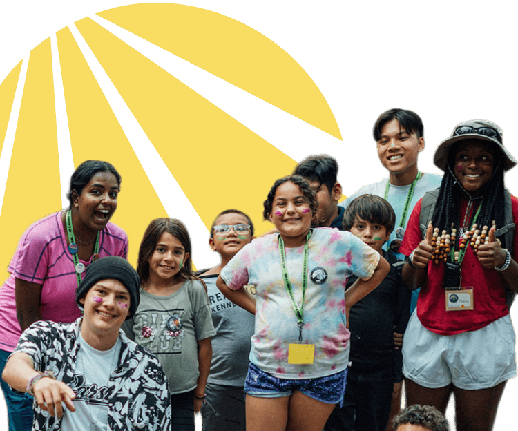 A group of children and teenagers standing at a camping program, with the Alliance for HOPE logo in the background